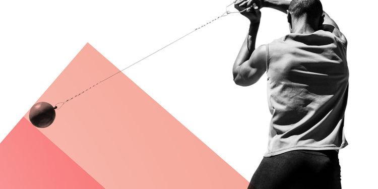 Rear view of sportsman practising hammer throw against colored background